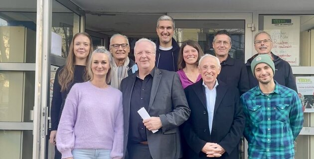 vor dem seeberger treff in chorweiler stehen mehrere menschen. 