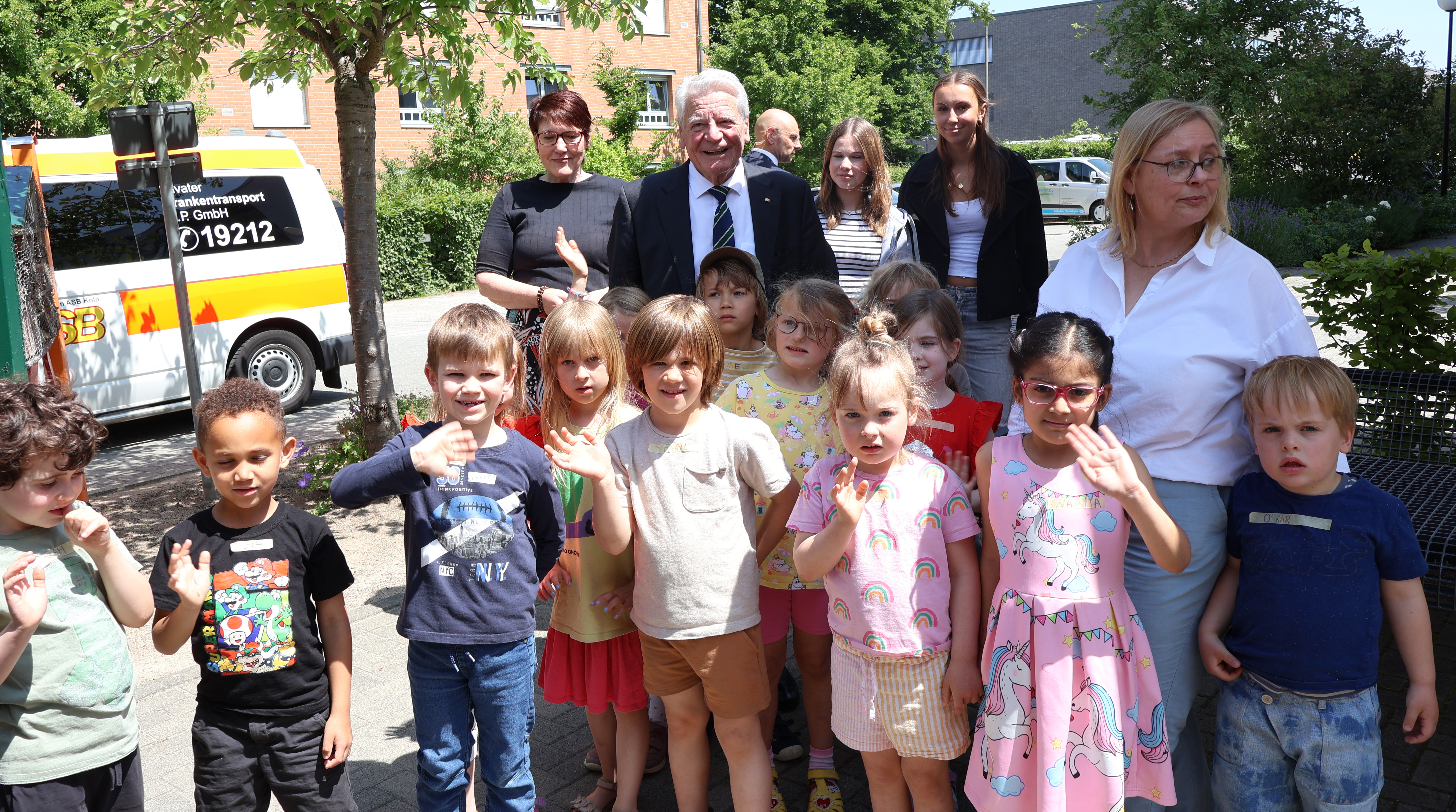 Joachim Gauck steht zusammen mit Kindern aus einer Kita