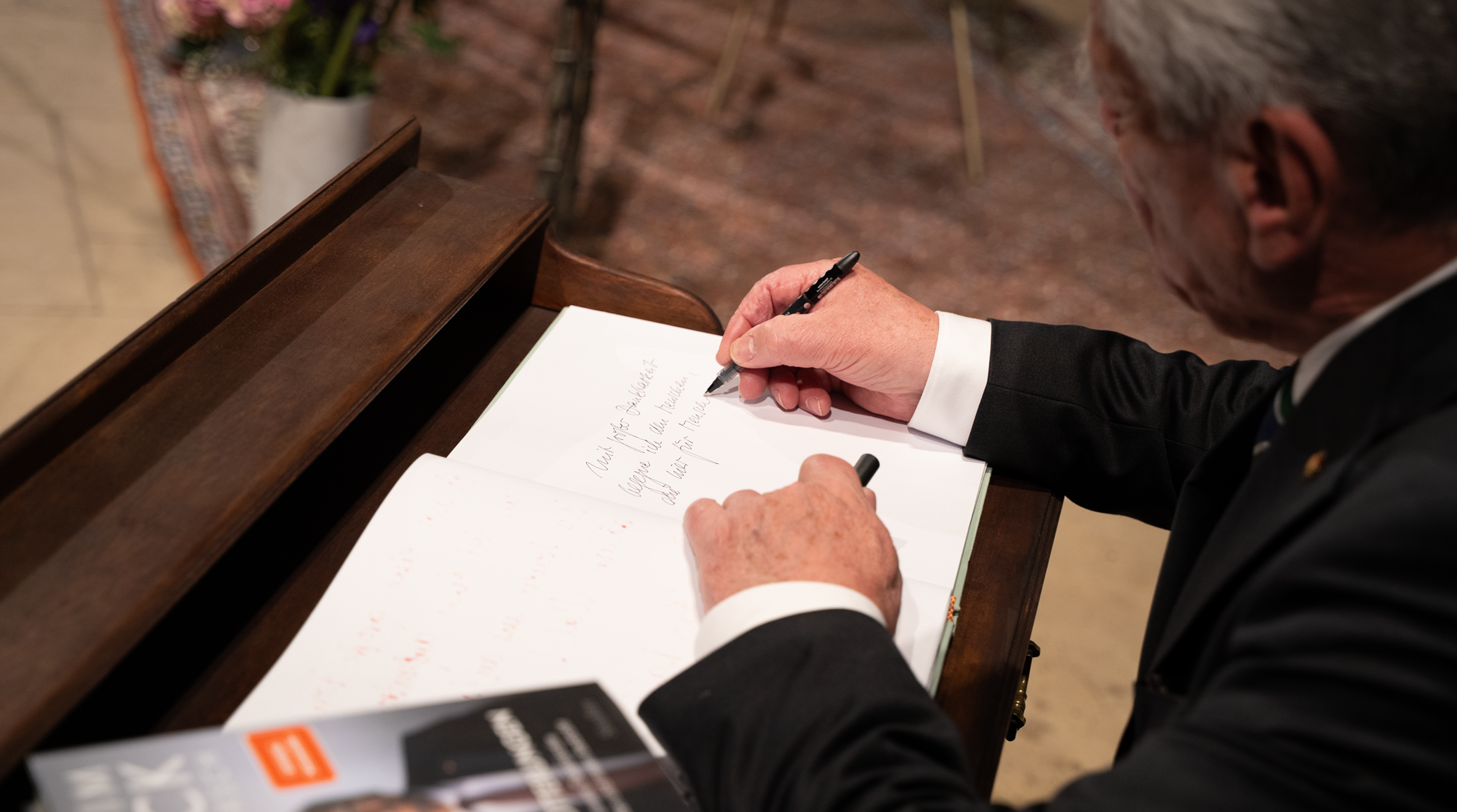 Joachim Gauck hinterlässt eine Widmung in einem Buch